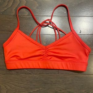 Alo Women’s sports bra in orange. Size XS.